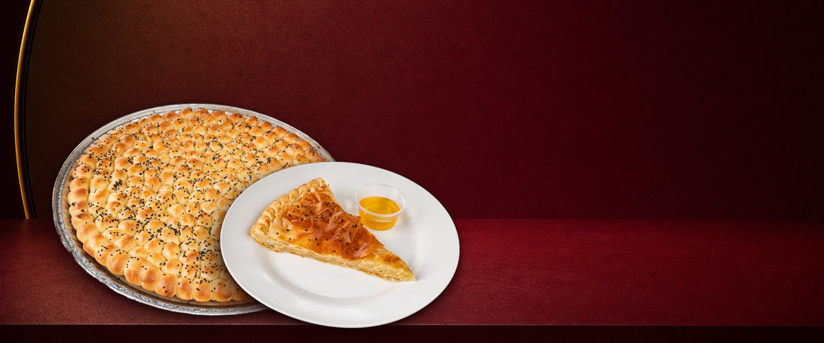 Golden Sabaya honeycomb bread and sabaya on a maroon backdrop