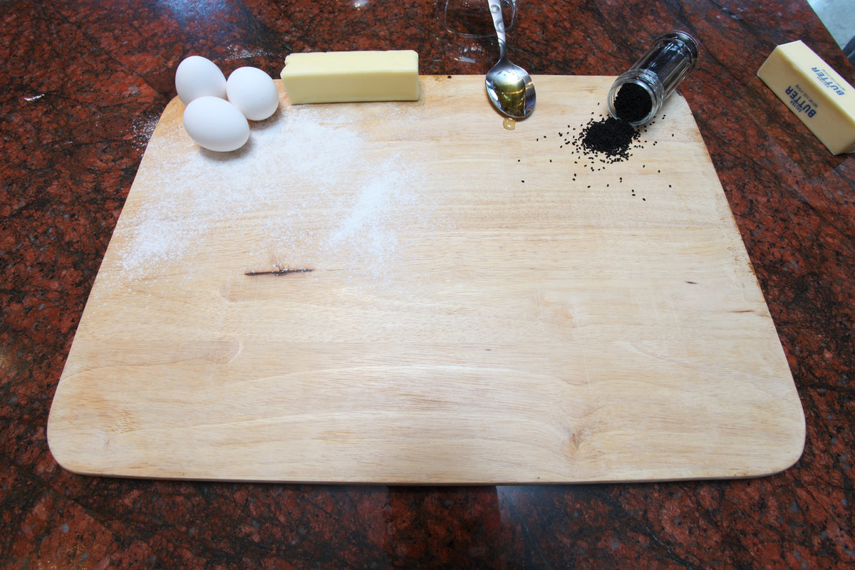 Wooden board with eggs, butter and nigella seeds, Golden Sabaya ingredients