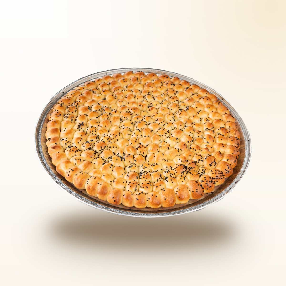 Golden Sabaya honeycomb bread on a round tray