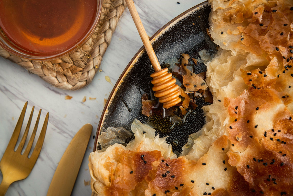 Golden Sabaya sabaya drizzled with honey, overhead view