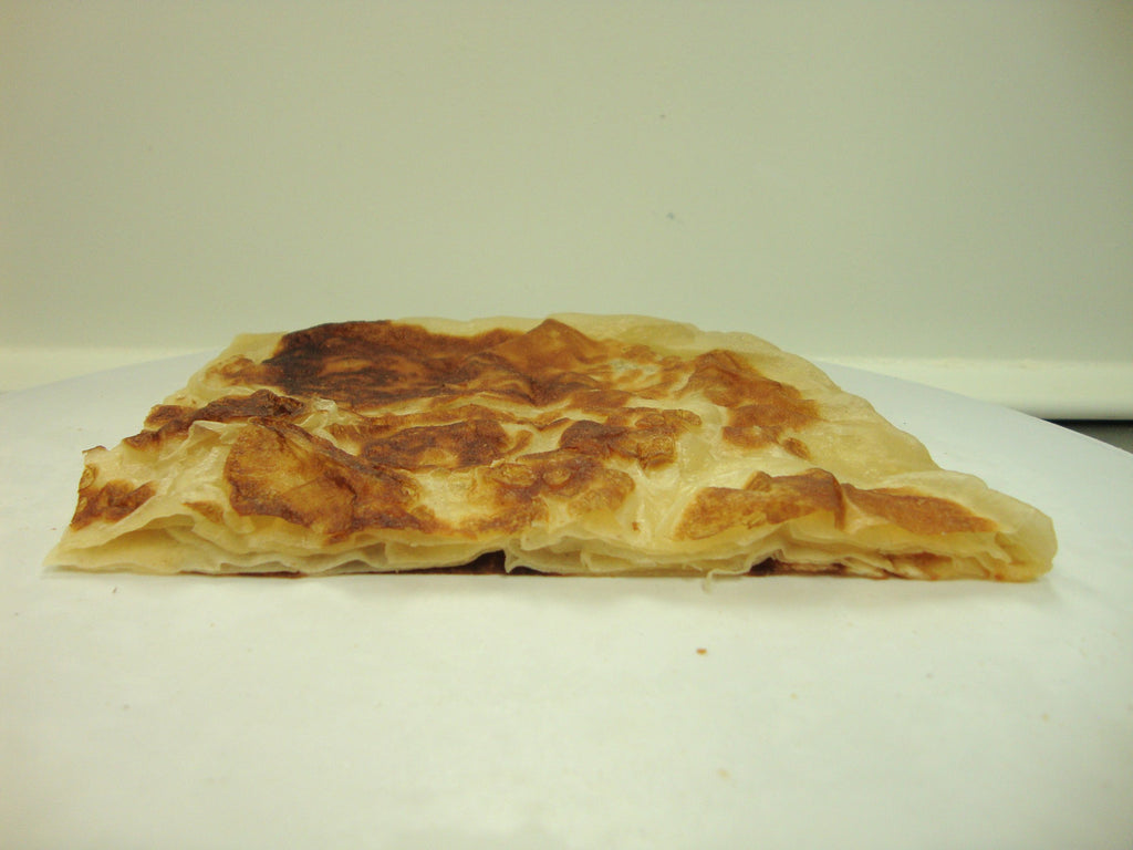 Folded tawa bread showing flaky layers